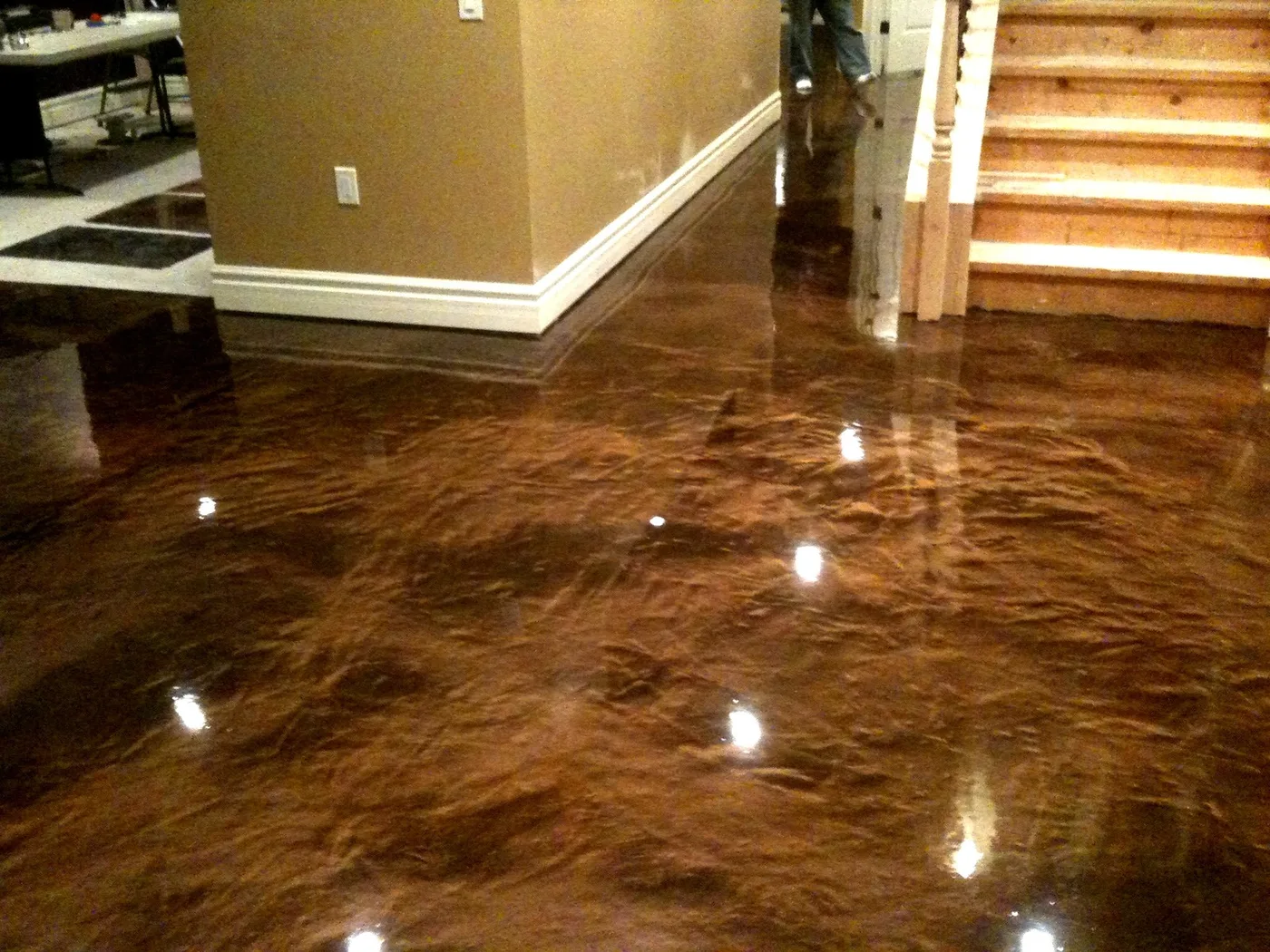 Copper metallic epoxy floor coating beside a staircase