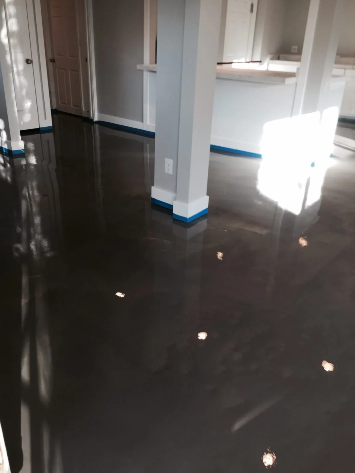 Dark metallic epoxy floor with a high gloss finish