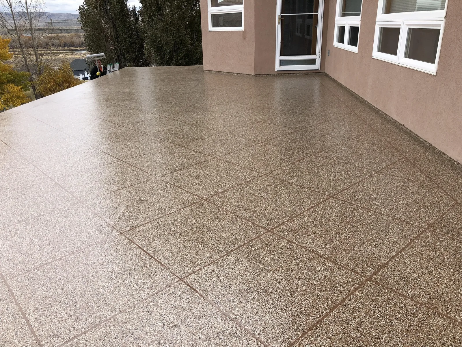 Flake patio coating with a scored tile pattern