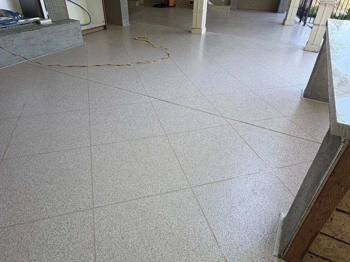 Flake patio coating with a scored tile pattern on a covered patio