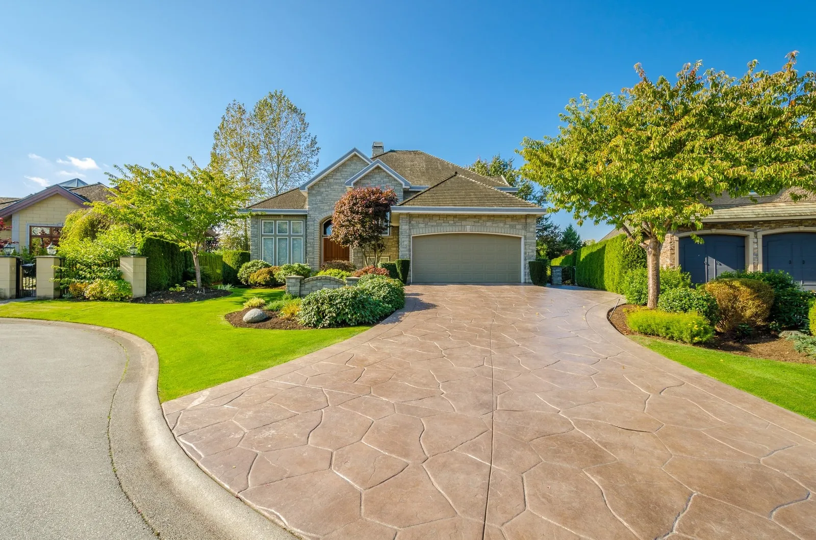 Sealed stamped concrete driveway with a deepened color