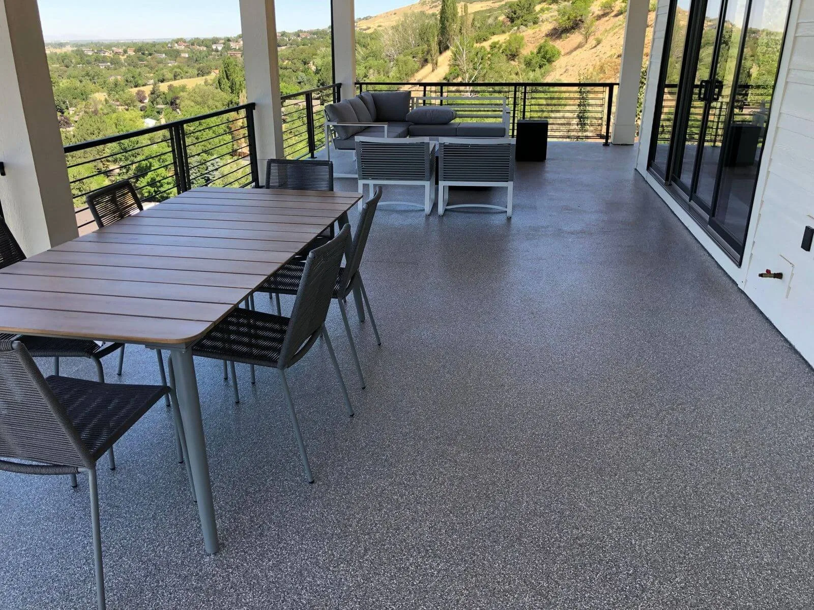 Waterproof decking under a covered deck with a table